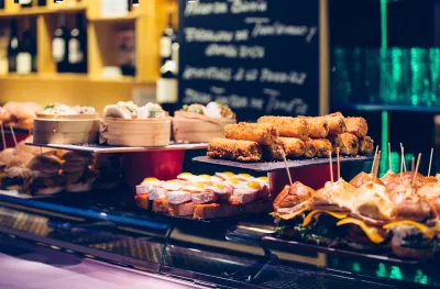 Several trays presented with a variety of Spanish tapas on the bar counter