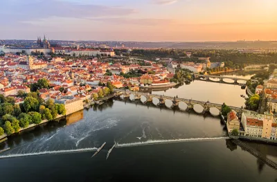 Aerial view of Prague Castle, cathedral and Charles Bridge at sunrise in Prague