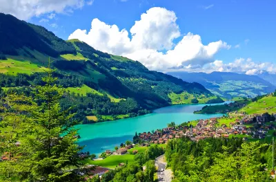 A scenic view or Swiss countryside as seen from a passing train