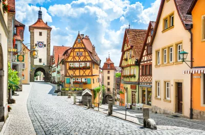 Historical half-timbered houses and cobbled streets of Rothenburg on a sunny day with blue sky and clouds in Franconia, Bavaria, Germany.