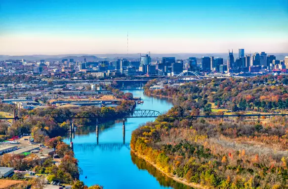 	The skyline of beautiful Nashville, Tennessee, in the distance along the banks of the Cumberland River