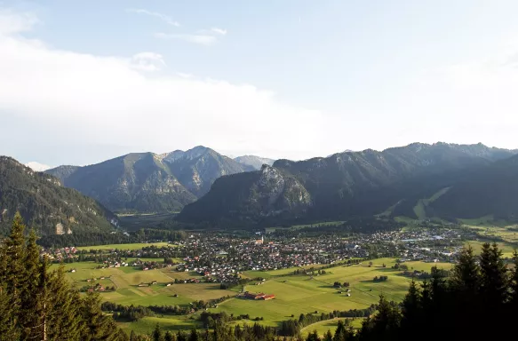 Panorama of Oberammergau with a view of mountain hilltops and green land, Germany.