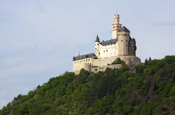 Distant view of the Medieval Marksburg castle surrounded by forestry at Braubach, Germany.