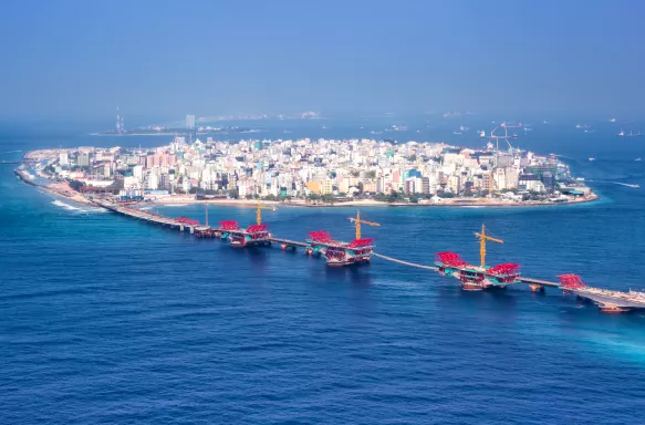 Aerial panorama of a bridge and the ocean surrounding Malé, Maldives.