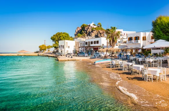 Bright and colourful view of Skala town with small beach in Patmos, Greece