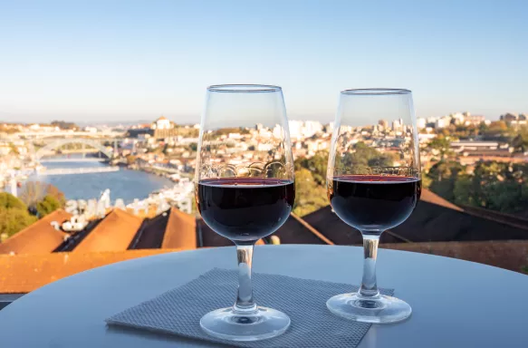 Two port wines in glasses with view of the Douro river and city of Porto, Portugal