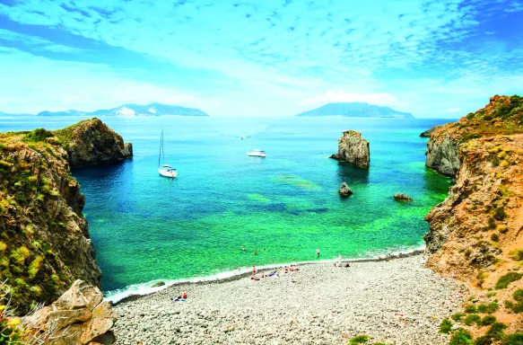 Bay of Panarea with small beach and rocky formations in Sicily, Italy