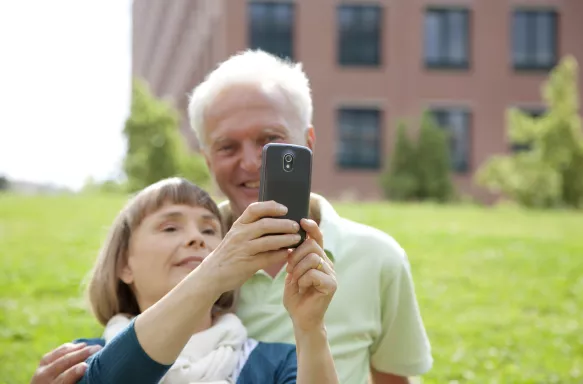 Senior couple posing for self-portrait with mobile phone