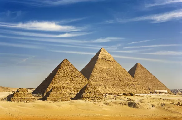 Desert view of the Great Pyramids of Giza under a clear sky