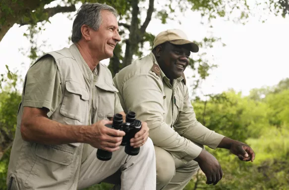 Senior man and Safari guide man smiling together