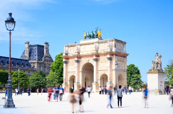 Blurred tourists and The Arc de Triomphe du Carrousel, Paris