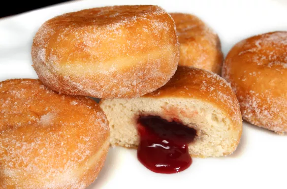 Close-up of fresh jam doughnuts coated in caster sugar