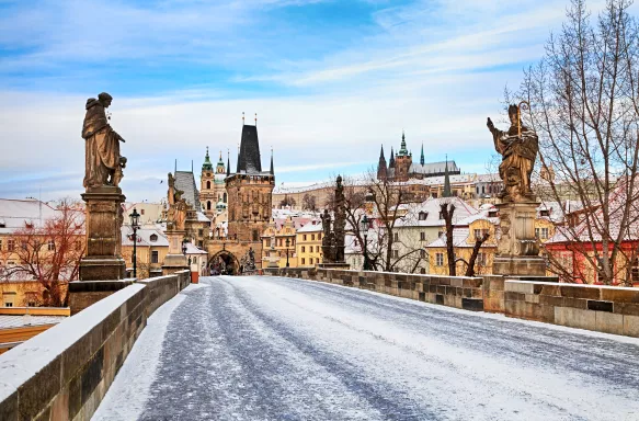 Charles Bridge lightly coated with snow and no people in Prague