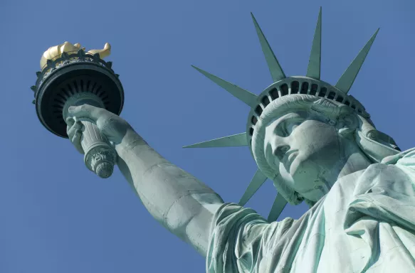 Close-up of the Statue of Liberty against a blue sky in New York