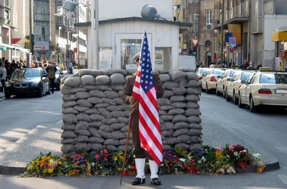 US Army Checkpoint with soldier holding the US flag in Berlin, Germany