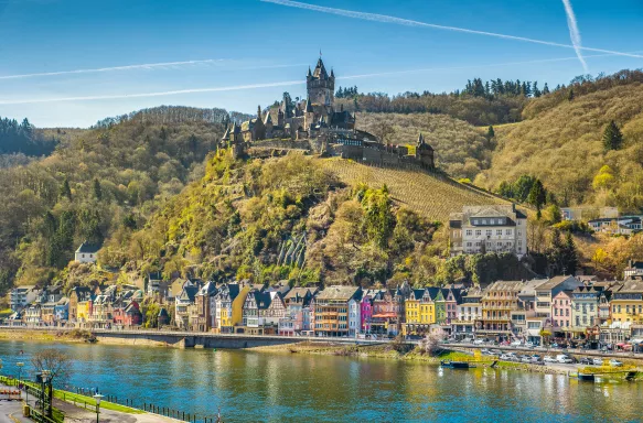 Town of Cochem with Reichsburg castle on top of a hill and scenic Moselle river during spring in Rheinland-Pfalz, Germany