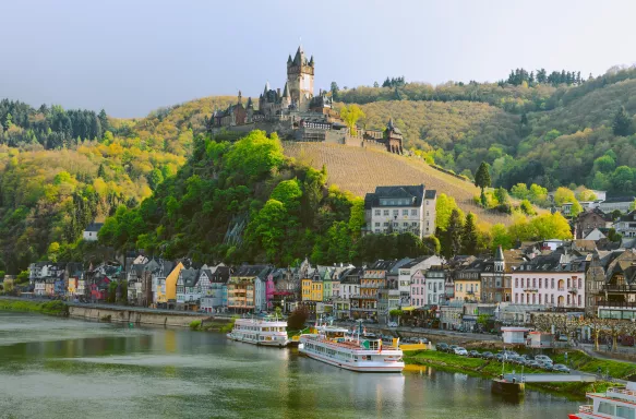 Beautiful city view of Cochem town with half-timbered colourful houses, hotels, restaurants and Reichsburg Imperial Castle on a mountain, Germany.