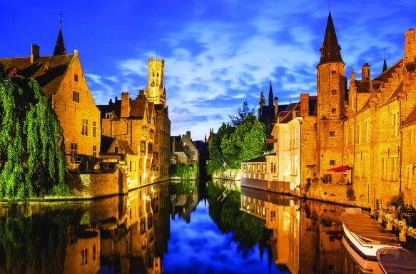 The Rozenhoedkaai canal and Belfort tower at twilight in Bruges