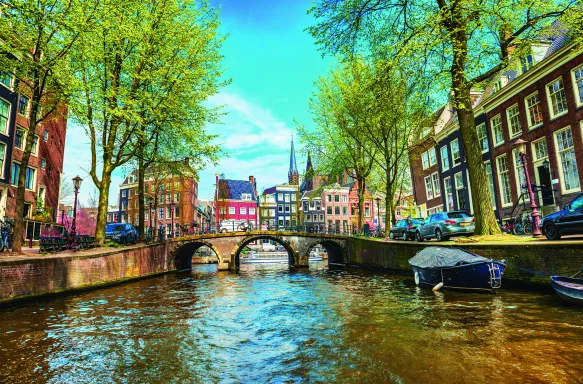 Water canal with traditional houses in Amsterdam