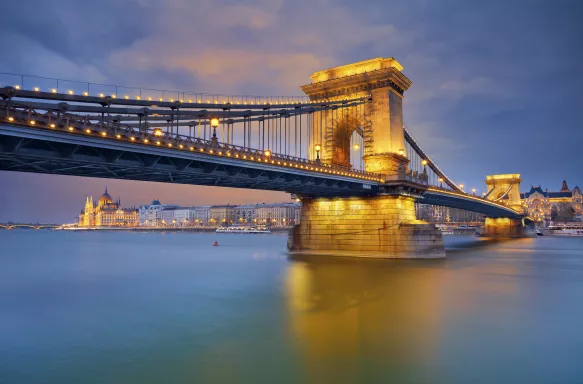 View of Chain Bridge and Budapest illuminated at twilight in Hungary