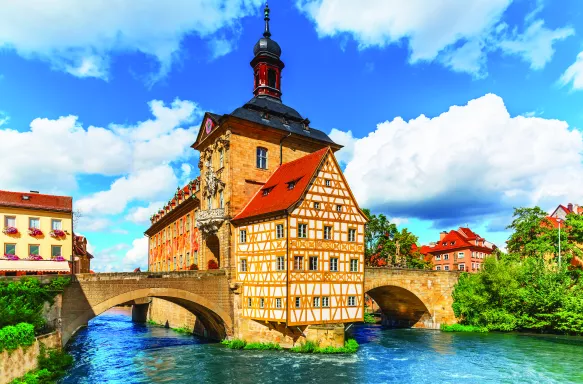 City Hall building with two bridges over the Regnitz river in Bamberg town, Germany