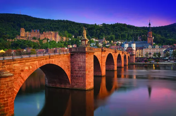 The old bridge in Heidelberg city and colourful evening sky in Germany