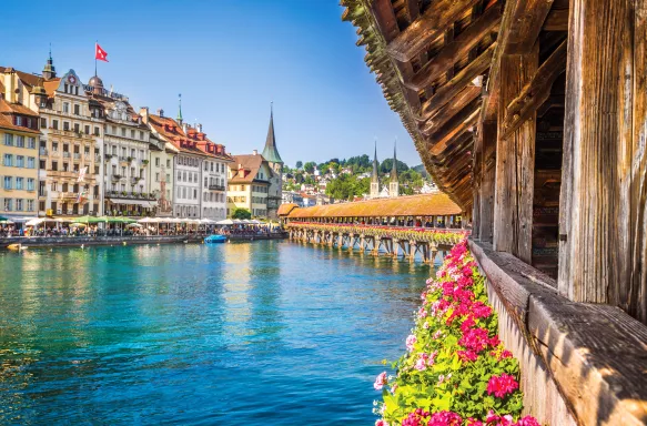 Famous Chapel Bridge in the historic city center of Lucerne, the city's symbol and one of Switzerland's main tourist attractions and views on a sunny day in summer, Canton of Lucerne, Switzerland