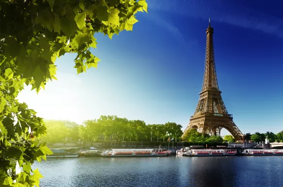 The River Seine and the Eiffel Tower during sunrise in Paris, France