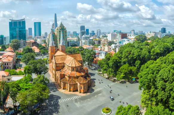 Notre Dame Cathedral with high-rise buildings in the background in Ho Chi Minh City, Vietnam.