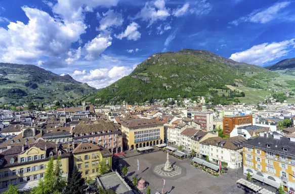 Aerial view of the Bolzano town, buildings and mountainous background