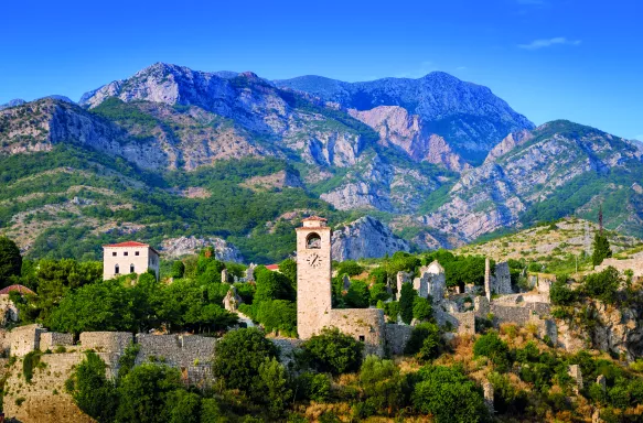 Aerial shot of old bar town with mountains and vegetation in Montenegro