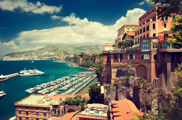 Buildings on the edge of Sorrento, with boats lined up in the water