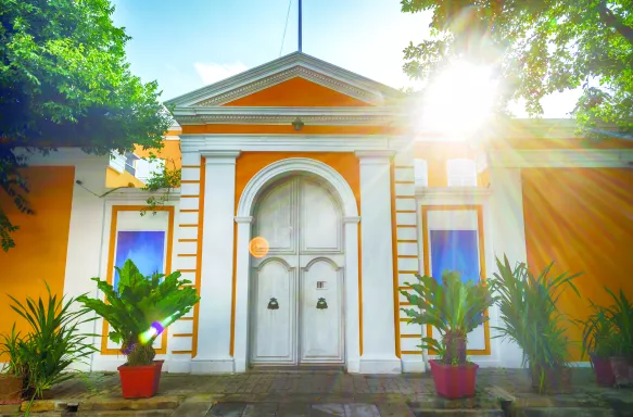 Colourful yellow and white house displaying French architecture. Pondicherry