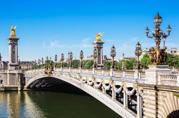 Pont Alexandre III bridge with ornate Art Nouveau lamps over the river Seine in Paris, France