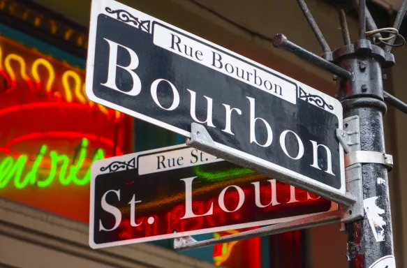 Street sign from in New Orleans, that is focused on the text saying Bourbon