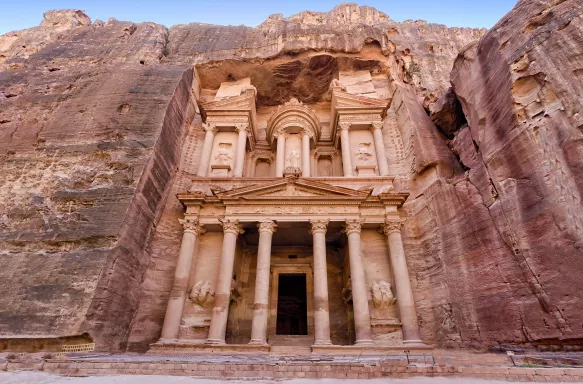 Front view of the Treasury, an elaborate carved sandstone temple in the side of a rock face, Jordan