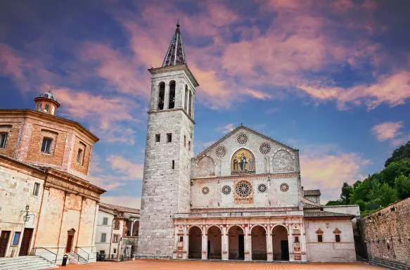 The medieval cathedral of Santa Maria Assunta with a colourful evening sky in Umbria, Italy.