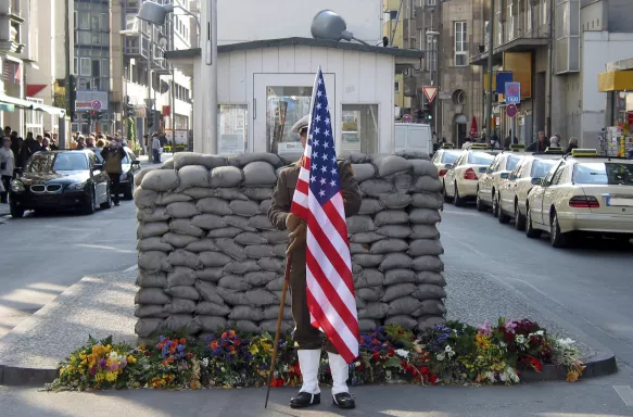 US Army Checkpoint with soldier holding the US flag in Berlin, Germany