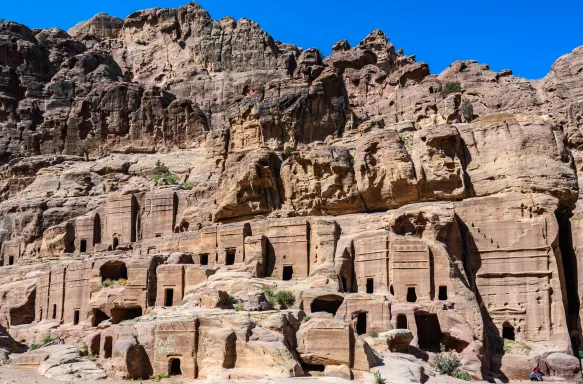 Desert canyon walls lined with carved stone tombs entrances, Jordan