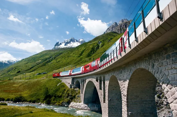 Switzerland railway Glacier Express train travelling through the Alps