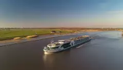 Distant side shot of the George Eliot, on a river