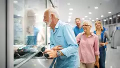 A happy elderly couple validating tickets at an airport