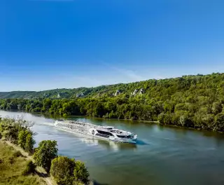 The Jane Austin luxury cruise boat from Riviera sailing down the Douro with blue skies