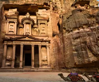 Image in front of Petra ancient city in Jordan with two camels sitting down