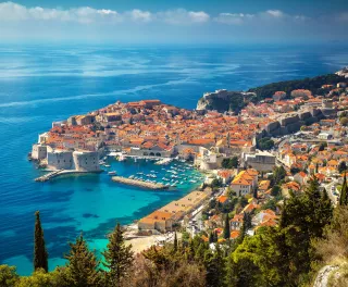 Aerial view of Dubrovnik city with old town houses and beautiful sea waters