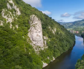 A large rock sculpture of decebalus overlooking the Danube River gorge 